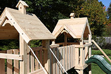 White cedar swing set wooden roofs.