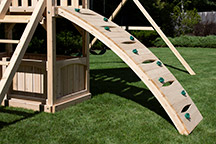 Triumph Play System's havendale loaded cedar swing set with rockwall and slide.