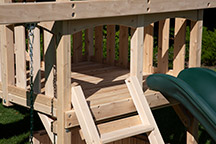 Triumph Play System's Kelton Space Saver Deluxe cedar swing set deck.